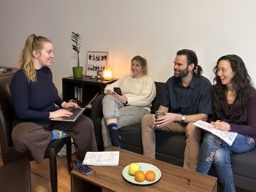 George Markey and colleagues taking part in a team meeting in a living room